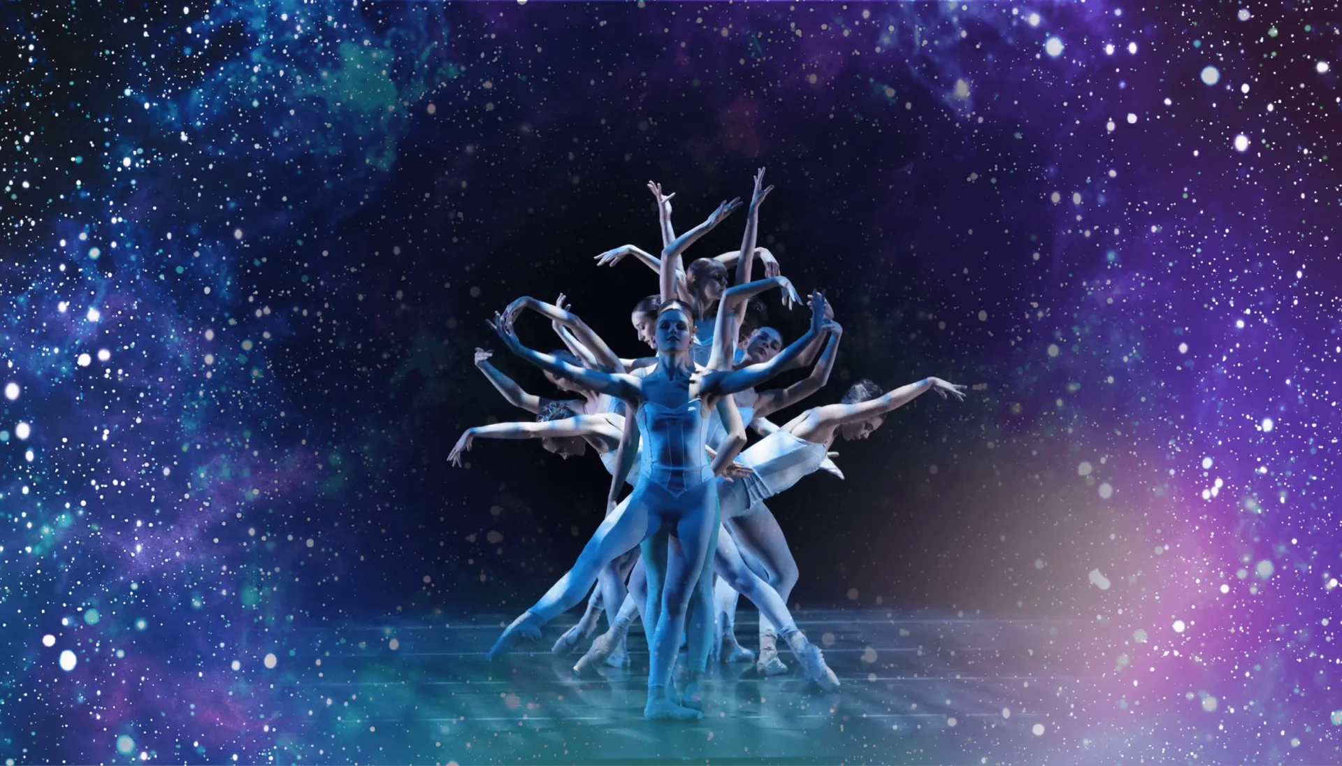 Ballet dancers layered in a radiant blue composite pose against a star-filled cosmic background.